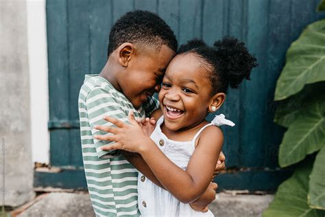 Two African American Kids Brother And Sister Hugging By Stocksy