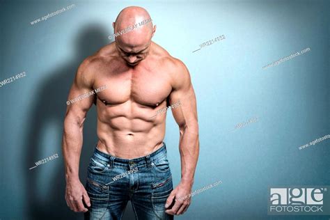 Composite Image Of Muscular Sad Man Looking Down Stock Photo Picture