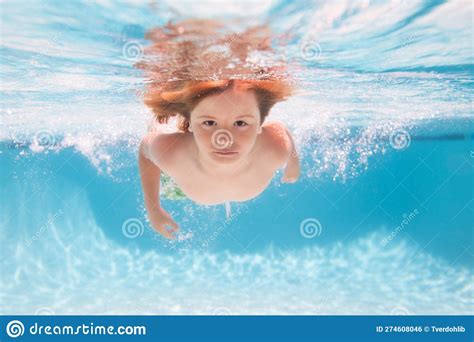 Child In Pool In Summer Day Young Boy Swim And Dive Underwater Under