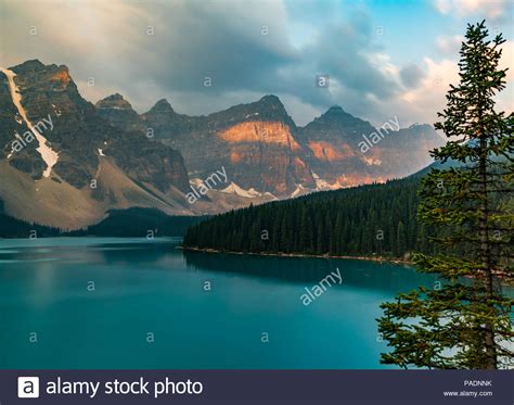 Sunrise With Turquoise Waters Of The Moraine Lake With Sin Lit Rocky