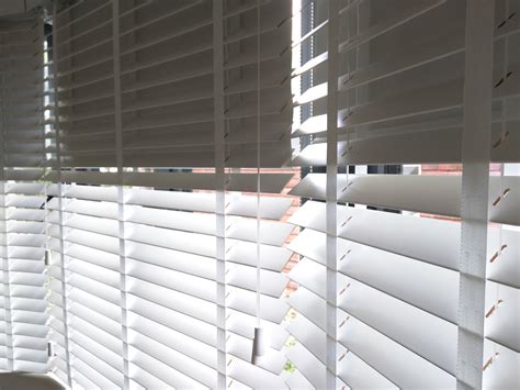 Wood Venetian Blinds With Blackout Roller Blinds Behind Fitted To Bay