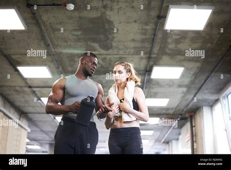 Trainer And Female Client Talking In Gym Stock Photo Alamy