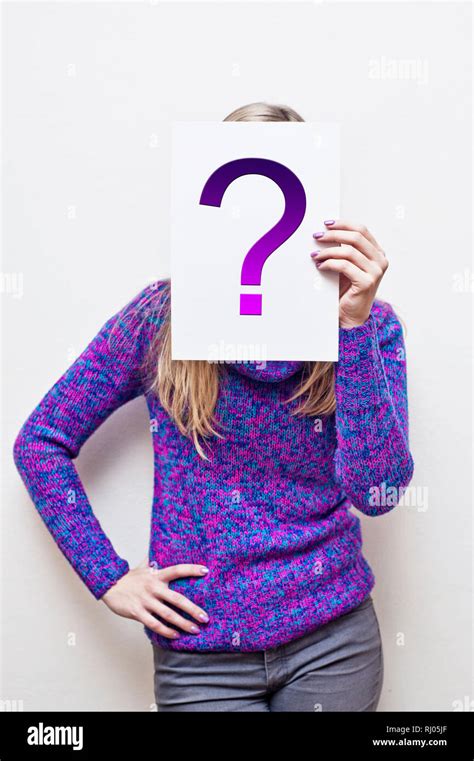 Woman Holding A Paper In Front Of Her Face With Question Mark Stock
