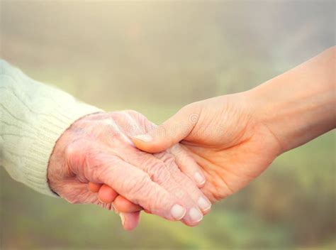 Elderly Woman Holding Hands With Young Caregiver Stock Photo Image Of