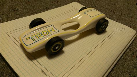 Watch the tutorial and catch some ideas here. The coolest blog ever.: Tron Pinewood derby car.