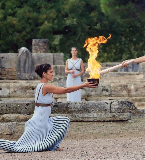 A High Priestess Passes The Olympic Flame At The Temple Of Hera During