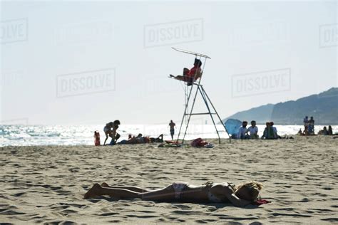 Teen Girl Sunbathing On Beach Stock Photo Dissolve