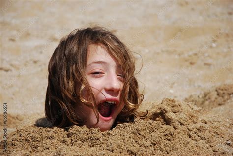 Funny Girl Buried In The Sand At The Beach Stock Photo Adobe Stock