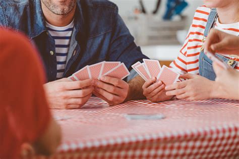 In its parents, kids & money survey published in 2019, asset management firm t. Family Playing Cards Stock Photo - Download Image Now - iStock