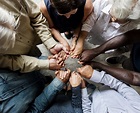 Group of diverse hands holding each other support together teamwork ...