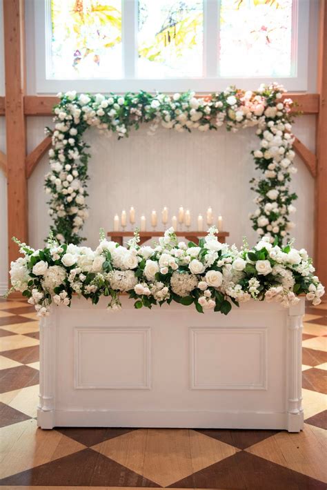 Traditional Ceremony Altar With White Flowers Greenery And Candles