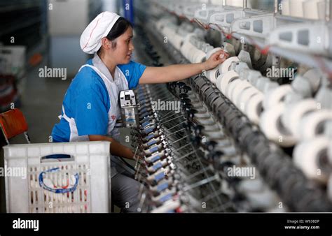 File A Female Chinese Worker Handles Production Of Yarn To Be