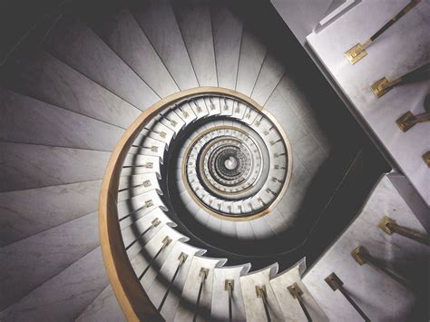 Impressive View Down A Stairwell With Spiral Marble Stairs Infinite
