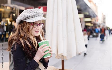 Tween Girl Drinking A Smoothie In A Busy City Shopping Mall Stock