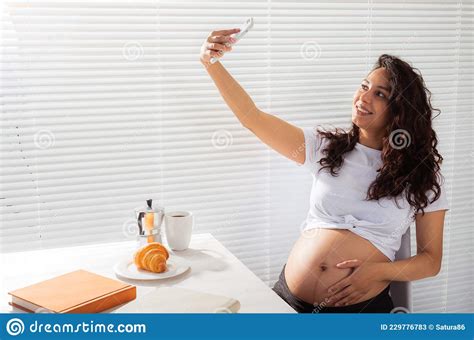 Pregnant Woman Takes Selfie On Her Smartphone While Breakfast