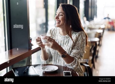Young Beautiful Woman Drinking Coffee In Restaurant Stock Photo Alamy