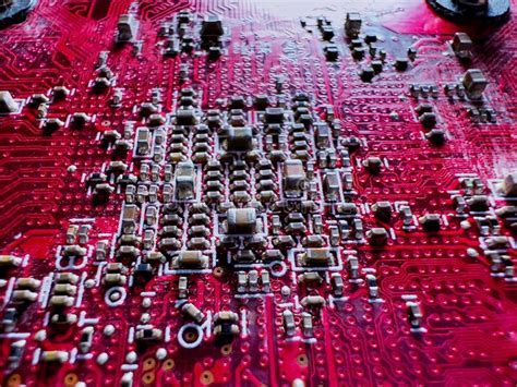 Close Up Of Transistors And Chips On The Red Circuit Board Stock Photo