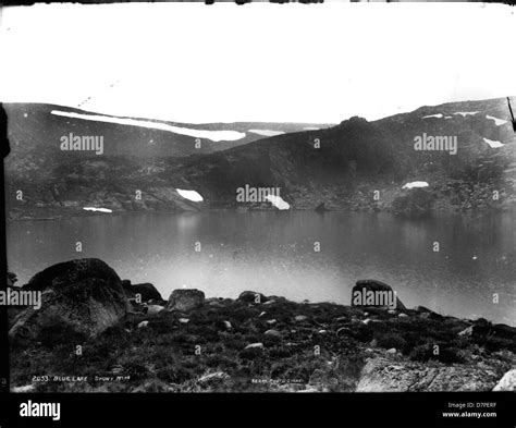 Blue Lake Snowy Mountains Stock Photo Alamy