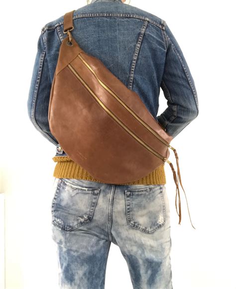 Converts to a clutch, fits everyday and travel essentials, dedicated pocket for mini tablets, and is crafted from a scratch & water resistant saffiano leather. Pin by Marlene Lee Fine Art on waist bags | Mens leather ...