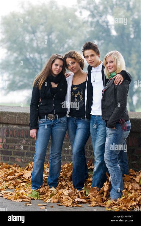 Group Of Four Caucasian Teenagers One Boy And Three Girls Smile Into