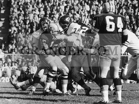 image of football game 1965 quarterback bart starr of the green bay packers being sacked for