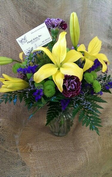 Floral Acres Vased Floral Arrangement Of Variegated Purple Carnations Yellow Asiatic Lilies