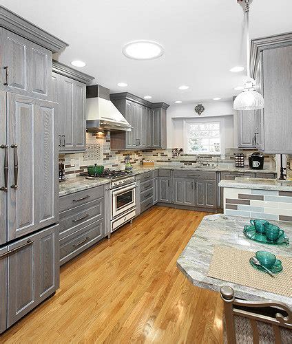 The cabinet hardware and barstools add extra dashes of black. Gray Stained Cabinets Ideas, Pictures, Remodel and Decor