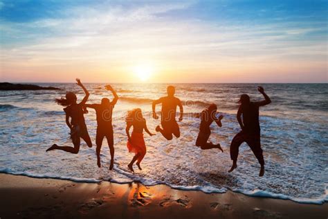 Silhouettes Of Young People Jumping With Excitement Stock Photo Image