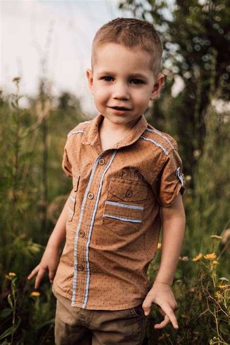 A Little Boy Stands In Nature And Smiles Stock Image Image Of Face