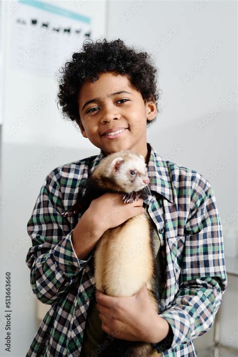 Vertical Medium Portrait Of Cheerful African American Kid Holding His