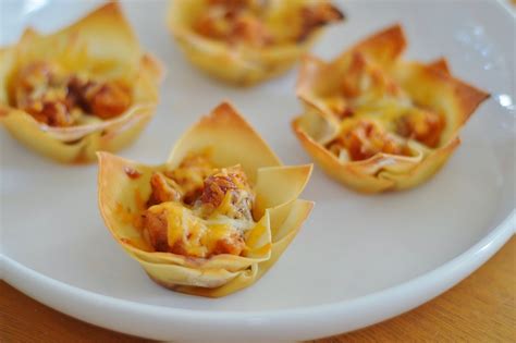 Moisten 2 adjacent edges of the wrapper with water and fold into a triangle. The Art of Comfort Baking: Barbecue Chicken Wonton Cups