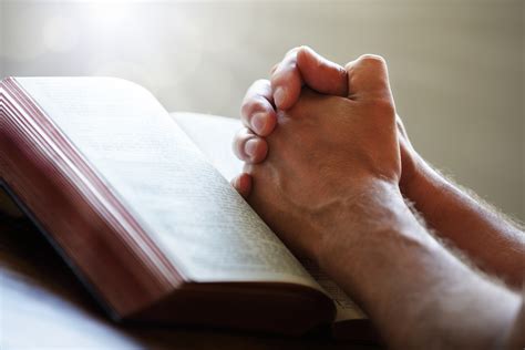 Praying Hands On A Holy Bible Hdgoswami