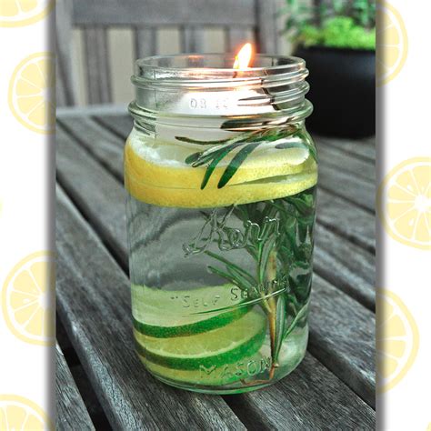 A Mason Jar Filled With Lemon And Cucumber Slices Sitting On Top Of A