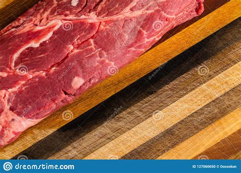 Uncooked Steak Sitting On Wooden Cutting Board Stock Photo Image Of