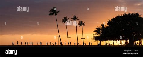 Tourists Watching The Sunset At Ala Moana Beach Park In Honolulu Oahu