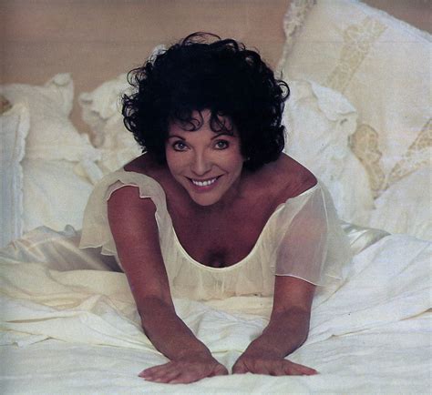 Joan Collins On The Bed During The Making Of Her Workout Tape In