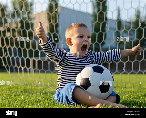 Boy With Football Shouting With Glee Stock Photo Alamy