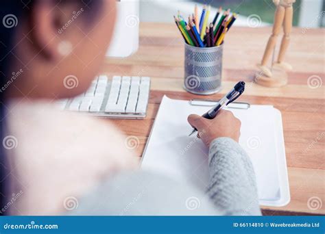 Over Shoulder View Of Woman Writing On White Sheet Stock Photo Image