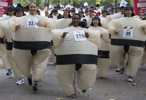 Participants Take Part In The Sumo Run In Battersea Park London