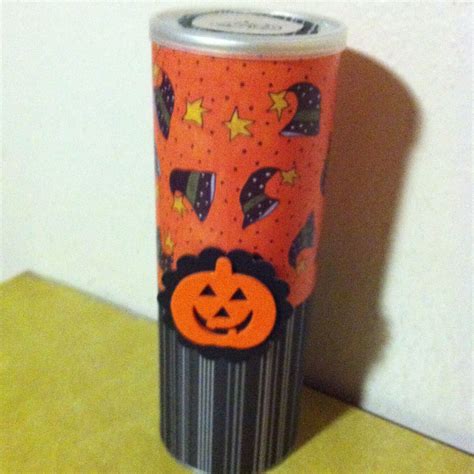 An Orange And Black Can With A Jack O Lantern Design On It