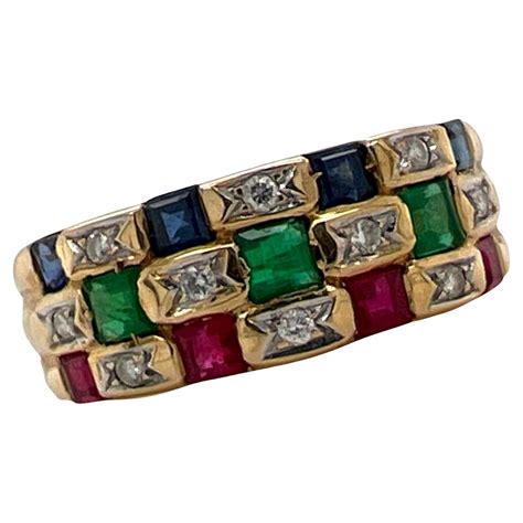 pair of 18 karat gold sapphire and diamond and emerald and diamond band rings for sale at 1stdibs