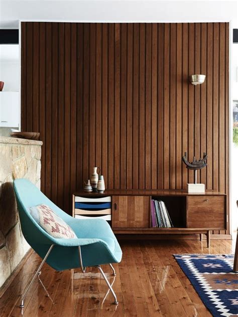 A Mid Century Modern Space With A Wood Plank Wall Matching Floor And