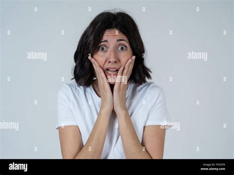 Close Up Of Latin Woman With Frightened Eyes Shocked Making Fear Anxiety Gestures Looking