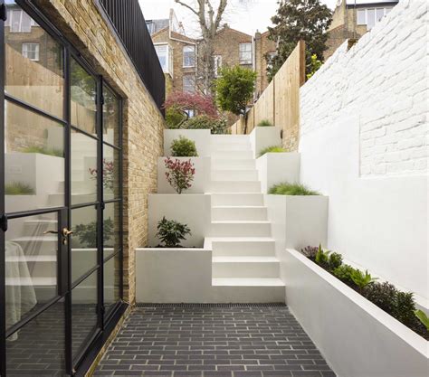 Stairs With Built In Planters Lead To The Back Garden At This Home