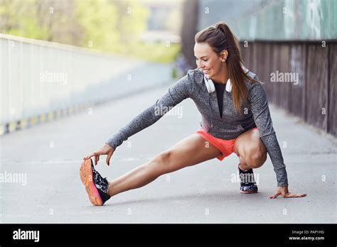 Female Runner Stretching Legs During Urban Workout Stock Photo Alamy