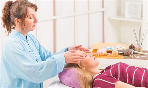 Professional Reiki Healer Doing Reiki Treatment To Young Woman