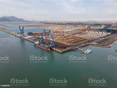 Aerial View Of Cargo Ship Unloading At The Timber Port Stock Photo