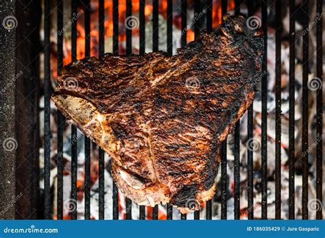 Grilling Big T Bone Steak On Natural Charcoal Barbecue Grill Stock