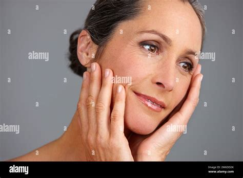 Ageless Beauty Studio Shot Of A Beautiful Mature Woman Posing Against