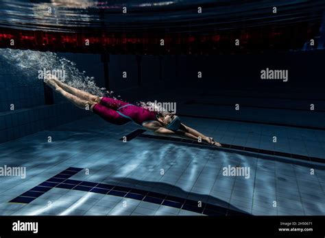 Underwater Shooting One Female Swimmer Training At Pool Indoors